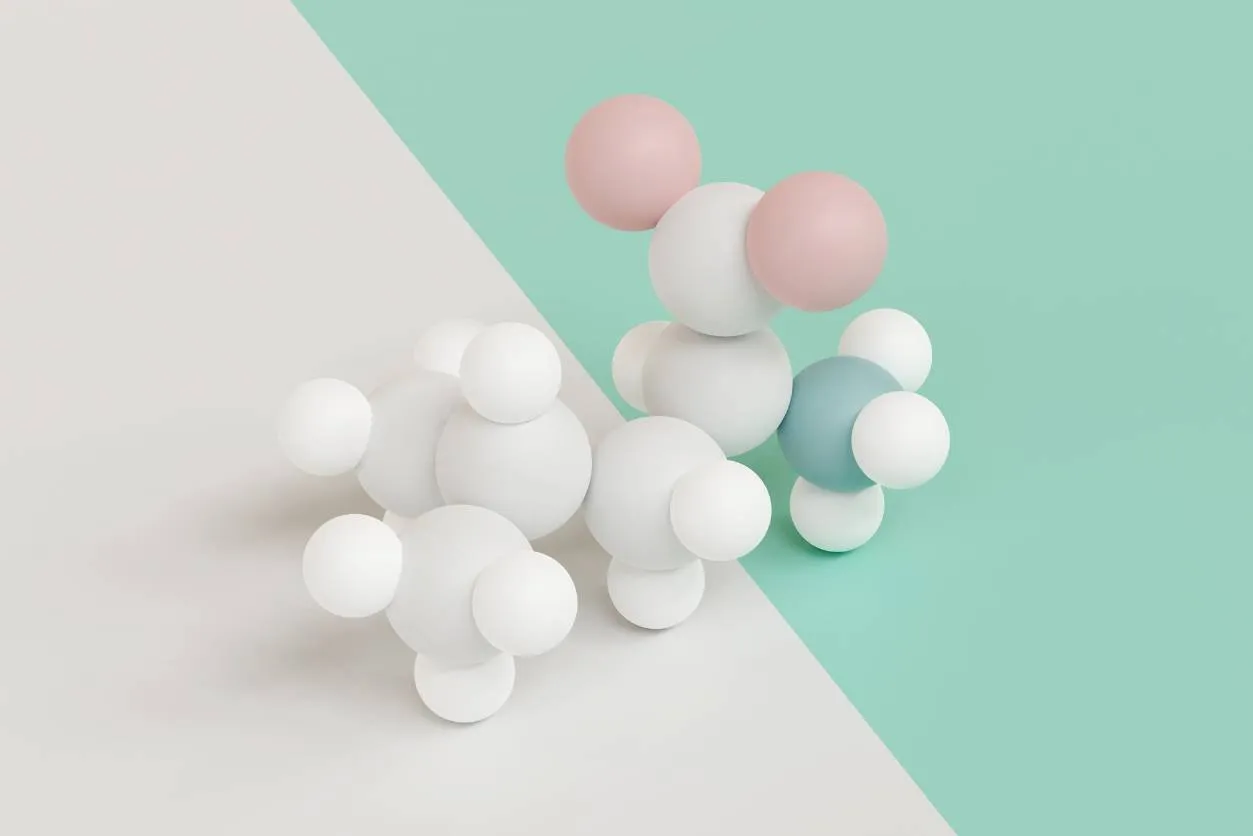 Molecular model of white, pink and green balls on a two-tone background