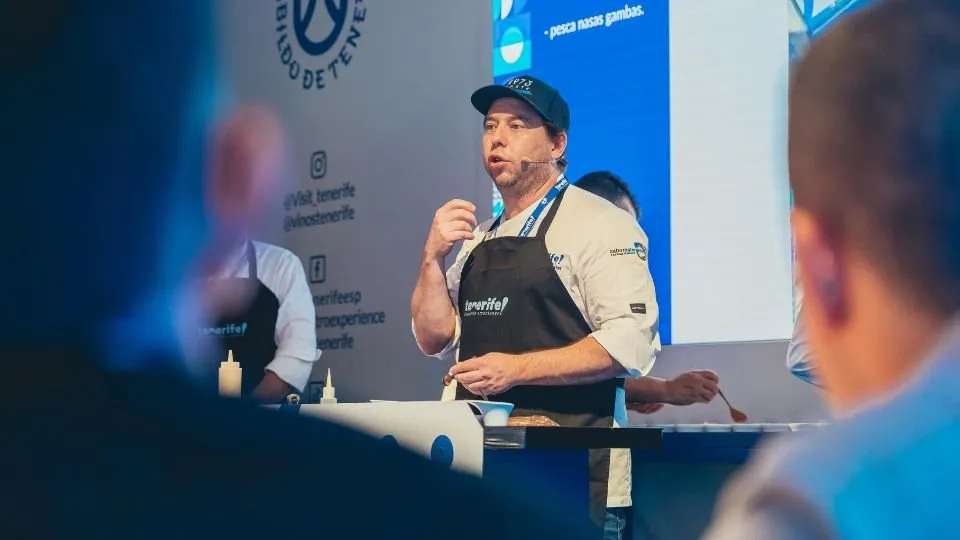 Diego Schattenhofer cooking live on stage wearing a Tenerife apron