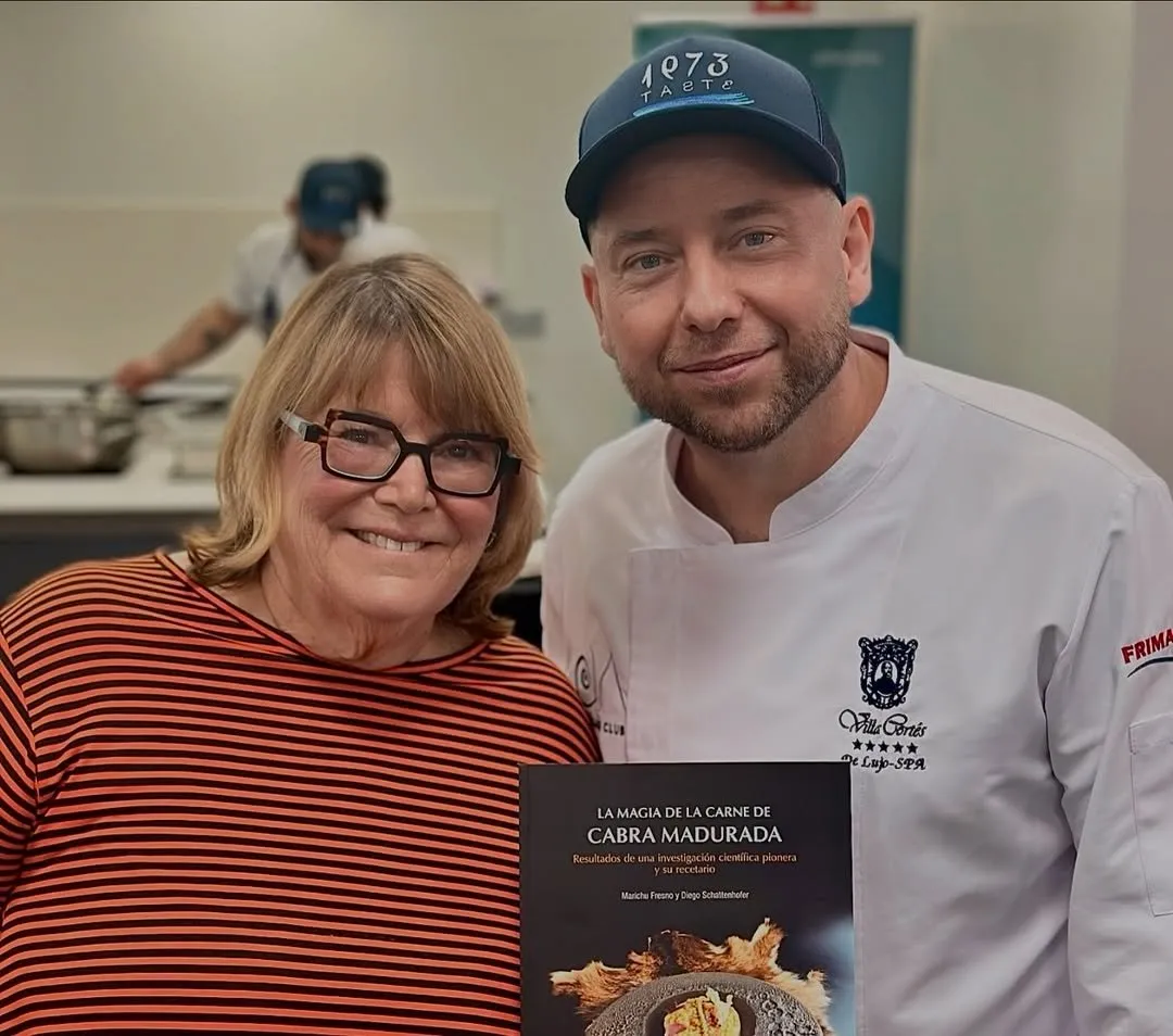 Marichu Fresno and Diego Schattenhofer hold a copy of the book in the kitchen