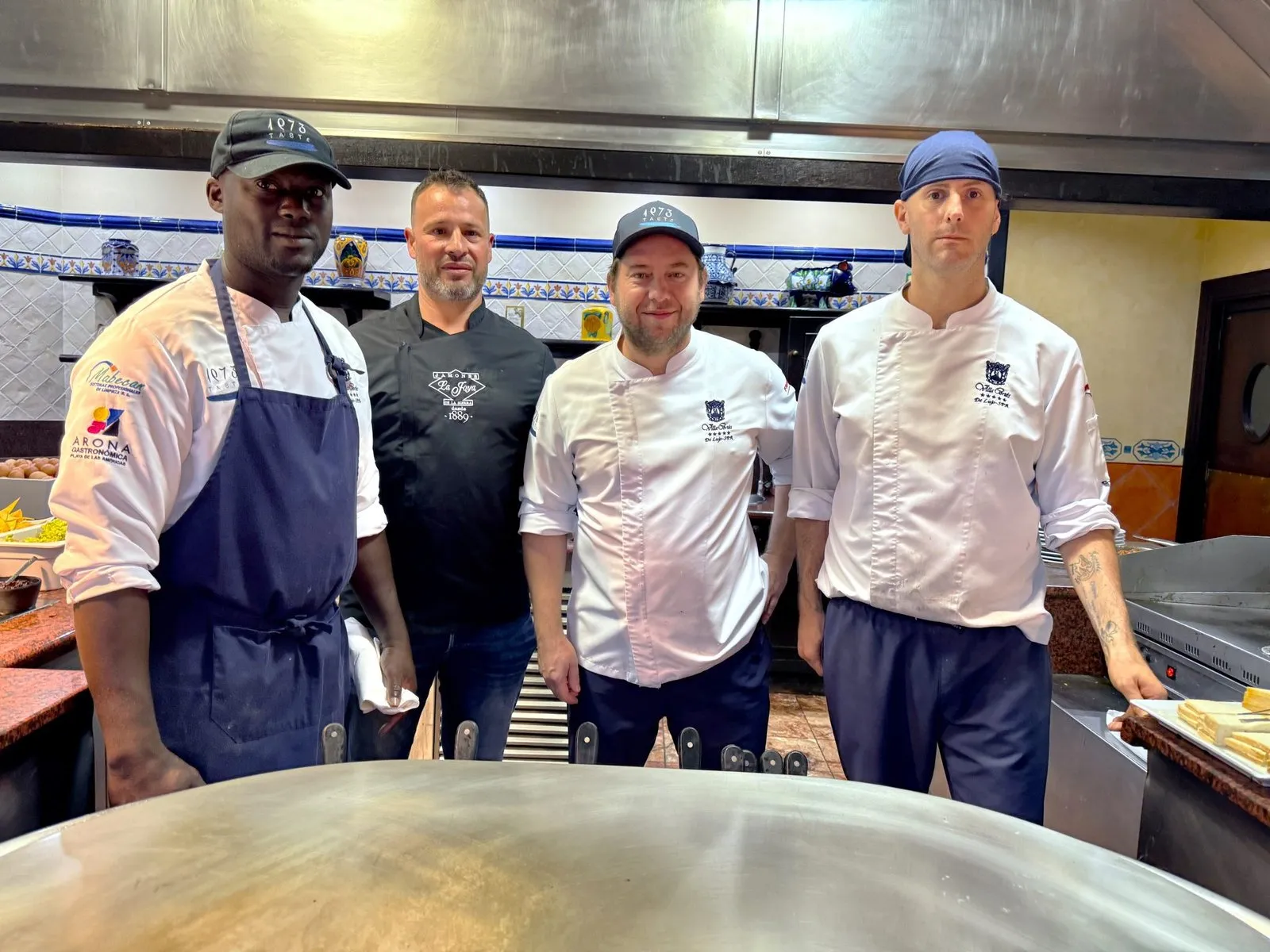 Diego Schattenhofer with his team behind the large circular hard chrome griddle