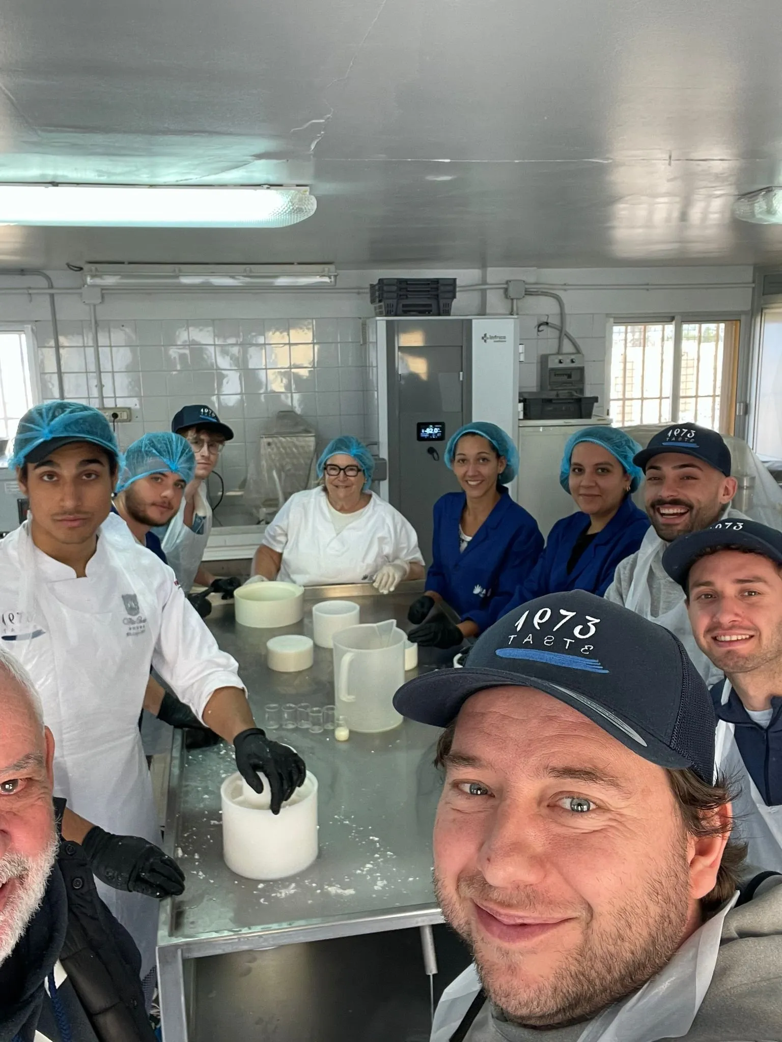 The ICIA and Taste 1973 team next to the cheese moulds