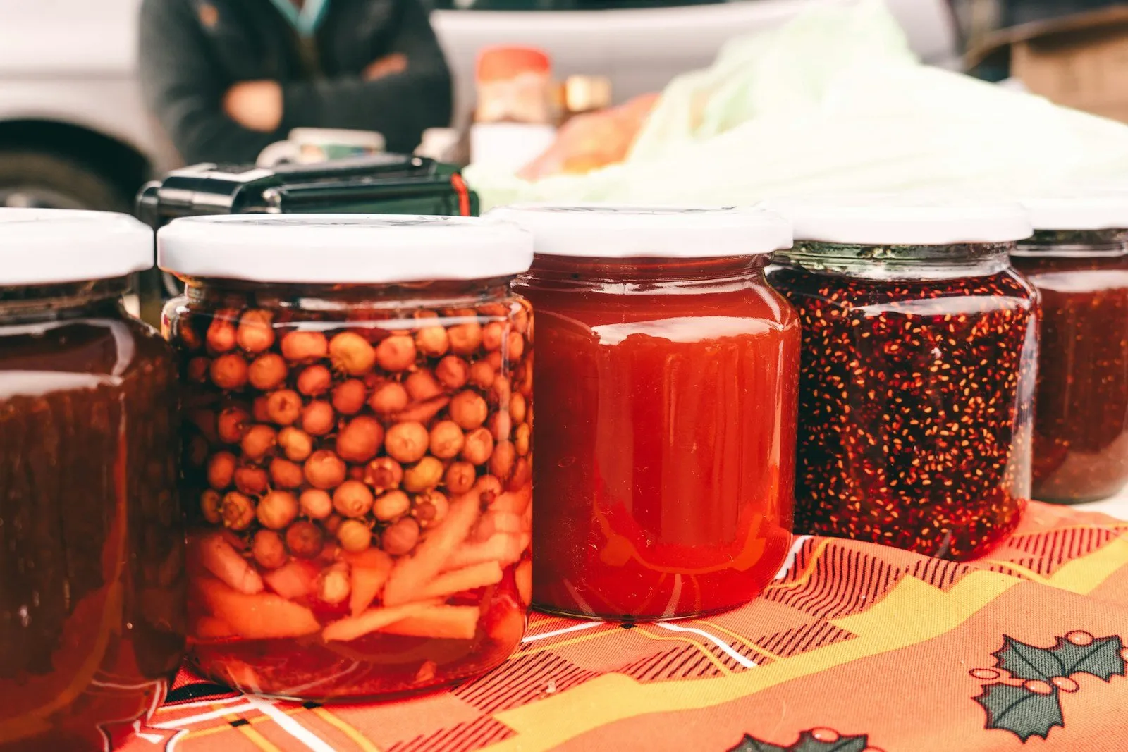Acidification: The Key to Preservation and Flavour Enrichment in Food - a table topped with jars filled with different types of food