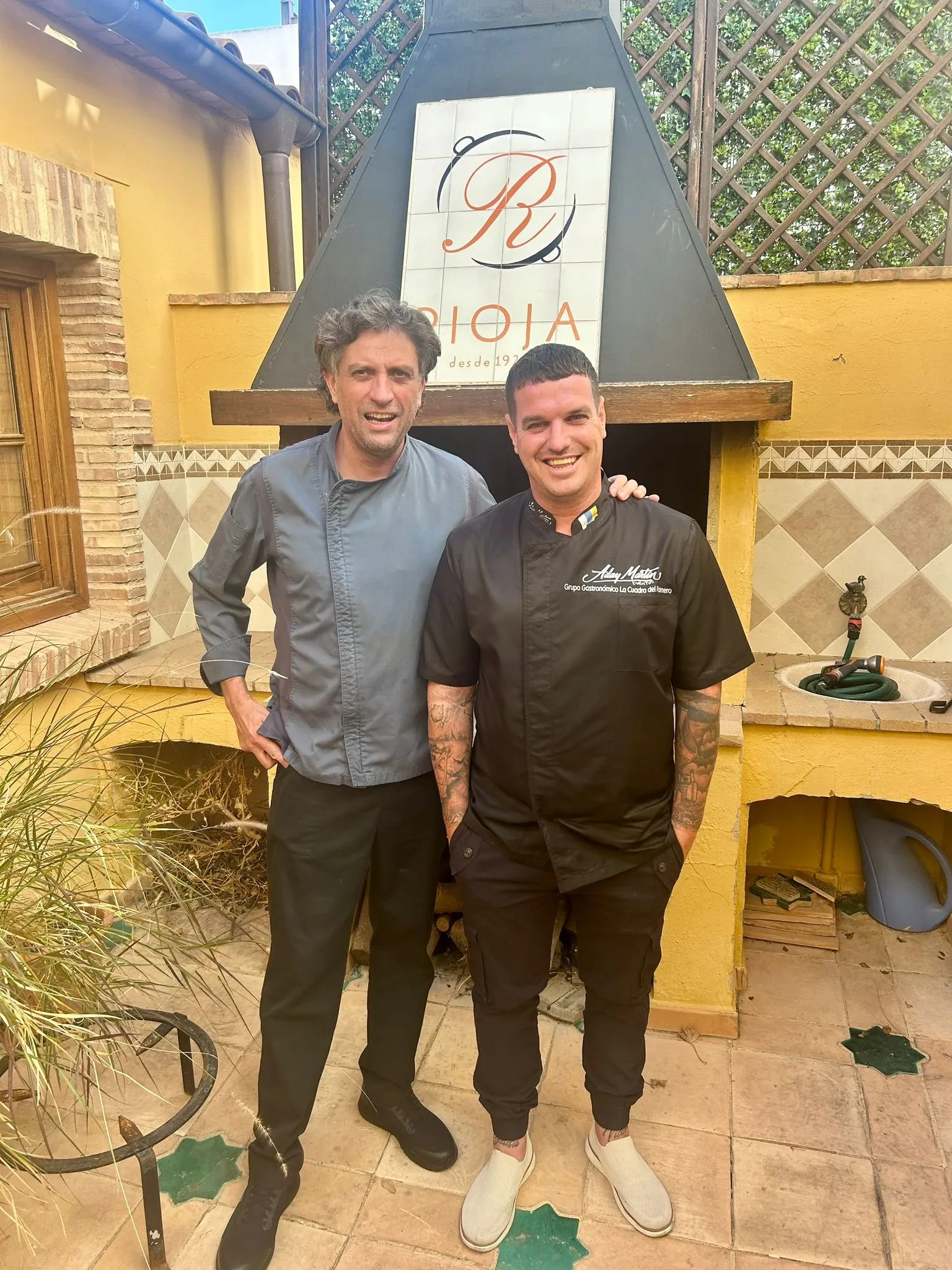 Aday Martín and Vicente Rioja in front of the wood-fired oven at the Rioja restaurant