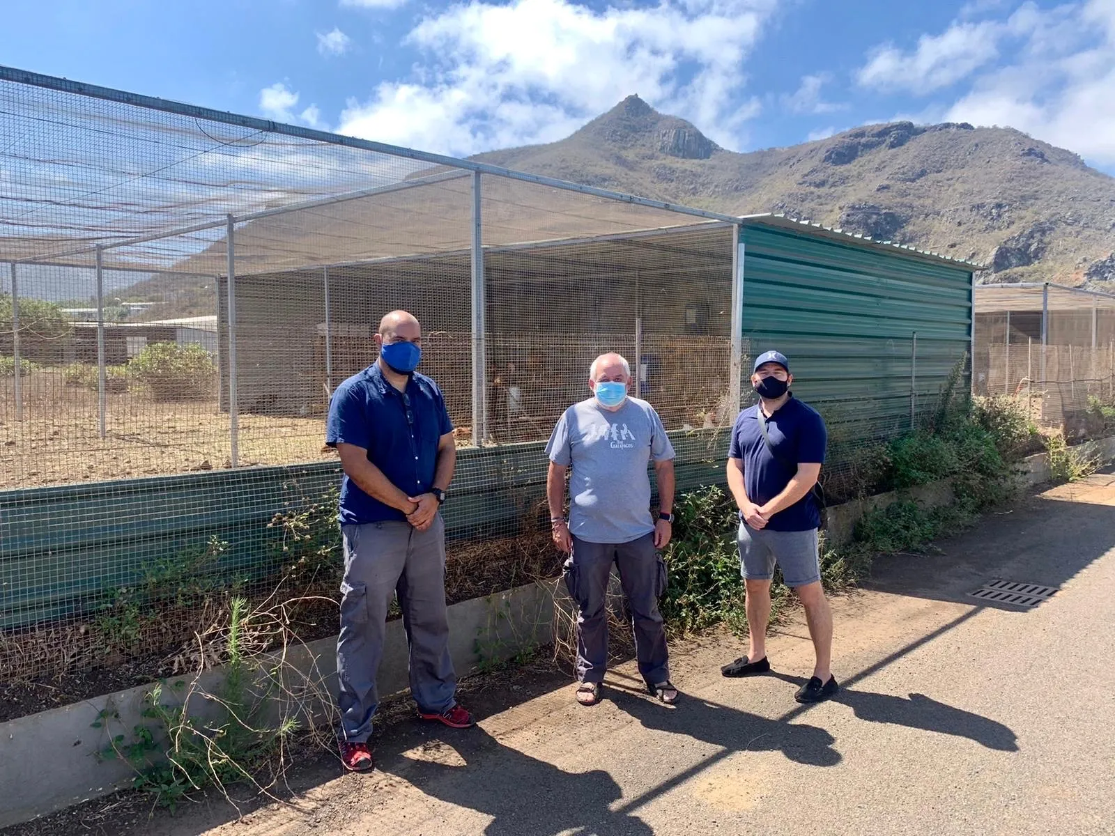 Three visitors wearing face masks in front of the ICIA’s outdoor pens