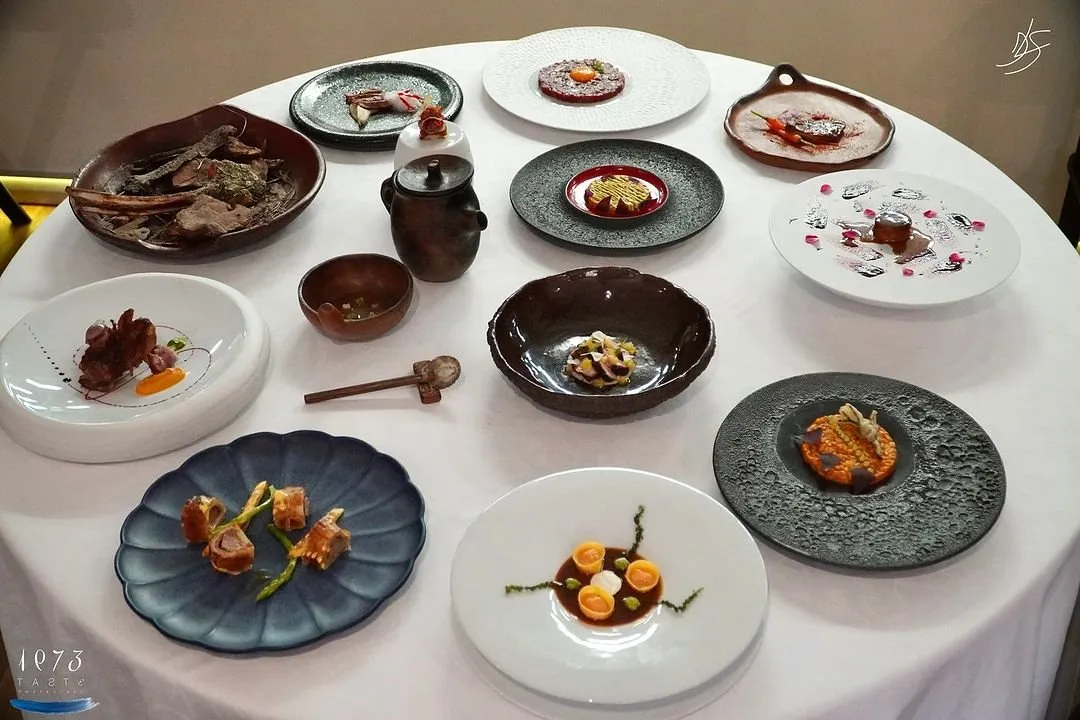 Round table with all the dishes from the book laid out for the photo shoot