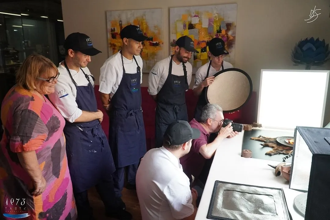 The Taste 1973 team watches the photographer shoot a dish