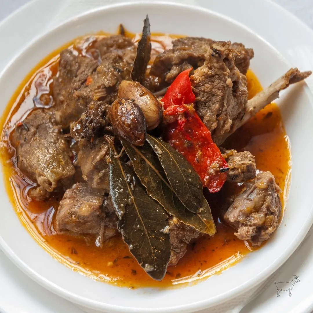 Goat meat stew in Canarian sauce with bay leaf, garlic and red pepper