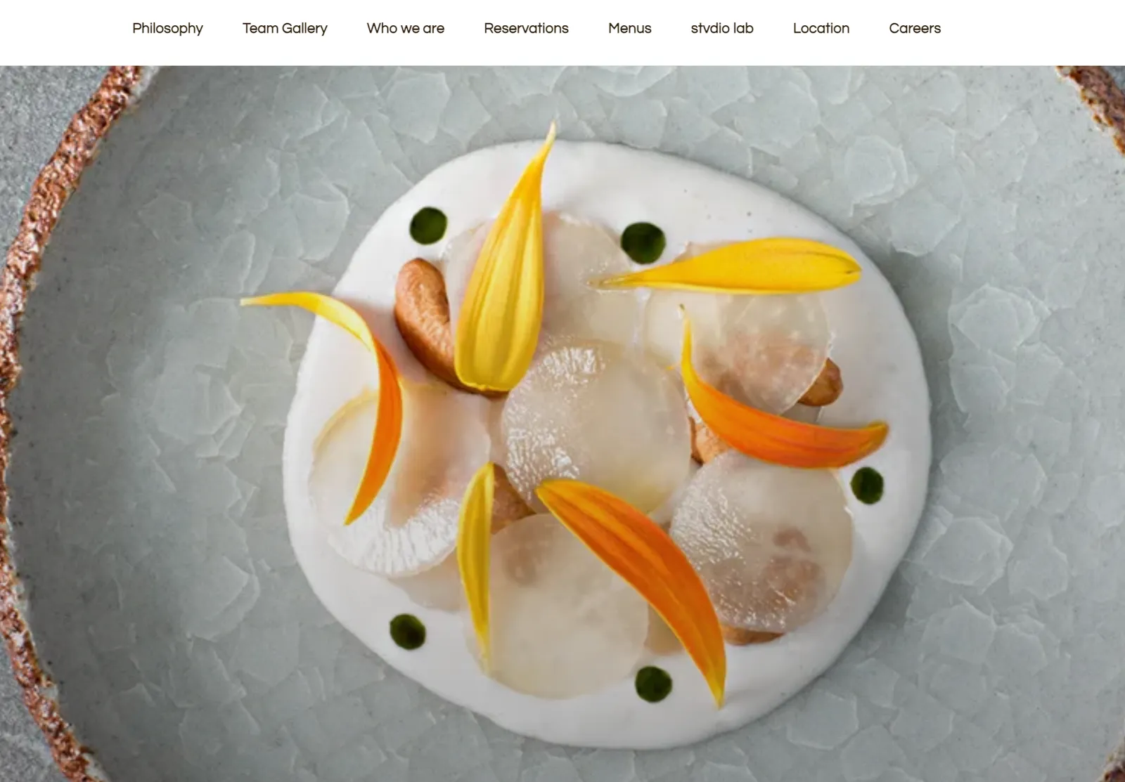 Gallery by Chele website: a dish with translucent sheets and orange petals