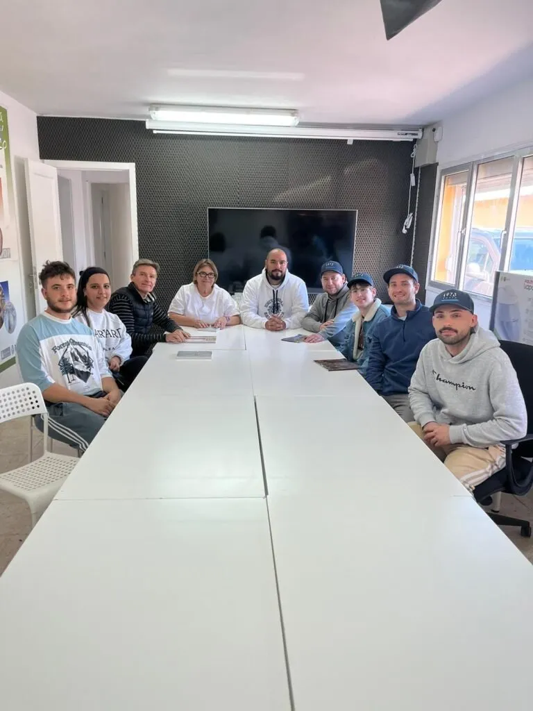 The project participants gathered around the work room table