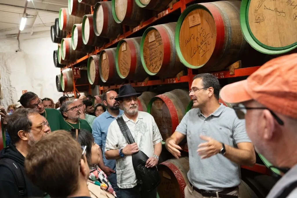 Participants at Terrae 2024 among wine barrels during a visit to producers in Gran Canaria
