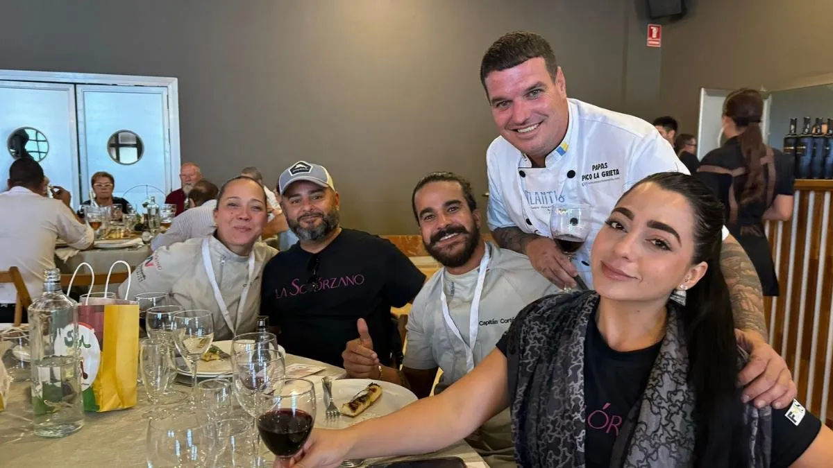 Cooks from the Atlantis restaurant raise a toast with wine around the table
