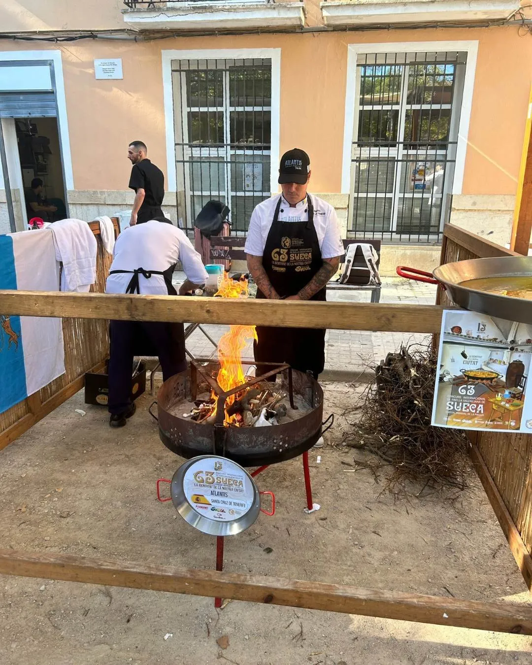 Aday Martín tends the wood fire at the stand during the Sueca competition