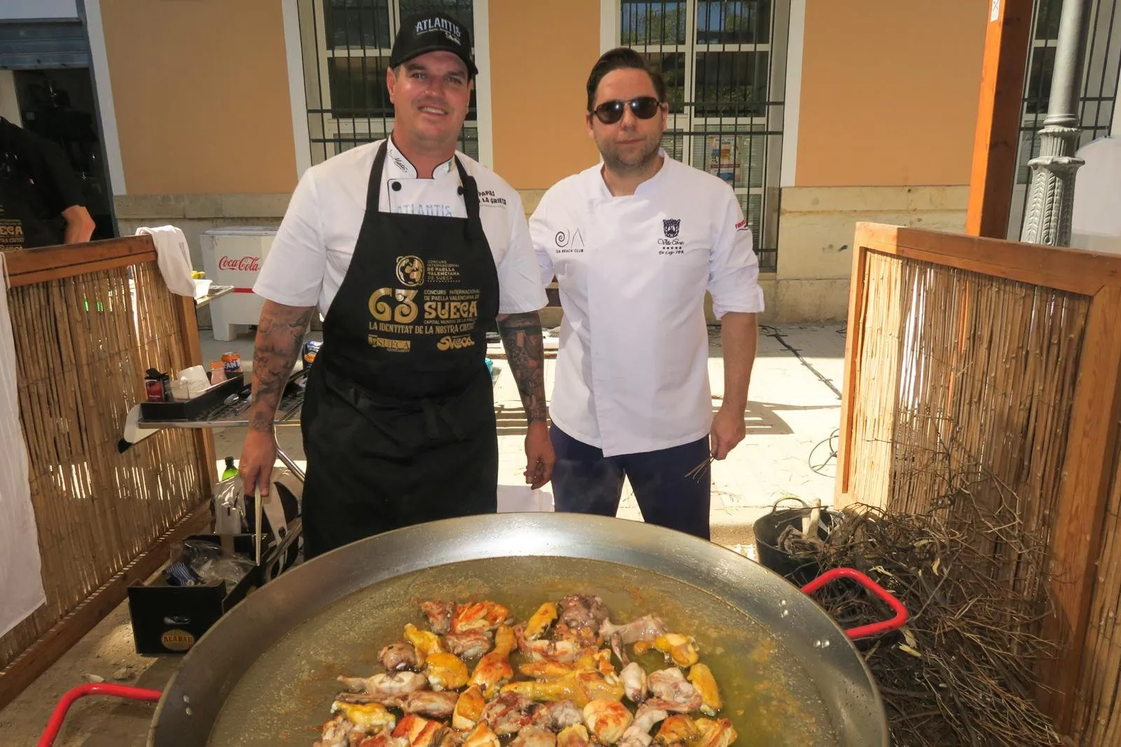 Two chefs pose with the paella after the 63rd Sueca Paella Competition