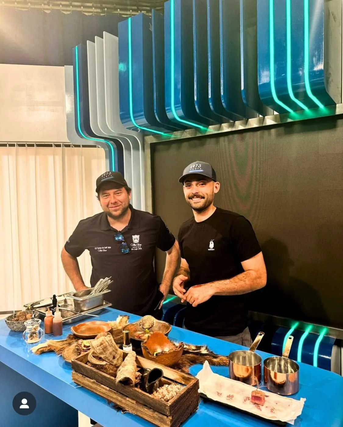 Diego Schattenhofer and a cook from his team behind the set table