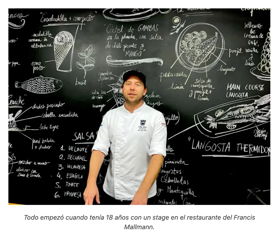 Diego Schattenhofer, in his white chef’s jacket, in front of a blackboard full of recipes drawn in chalk