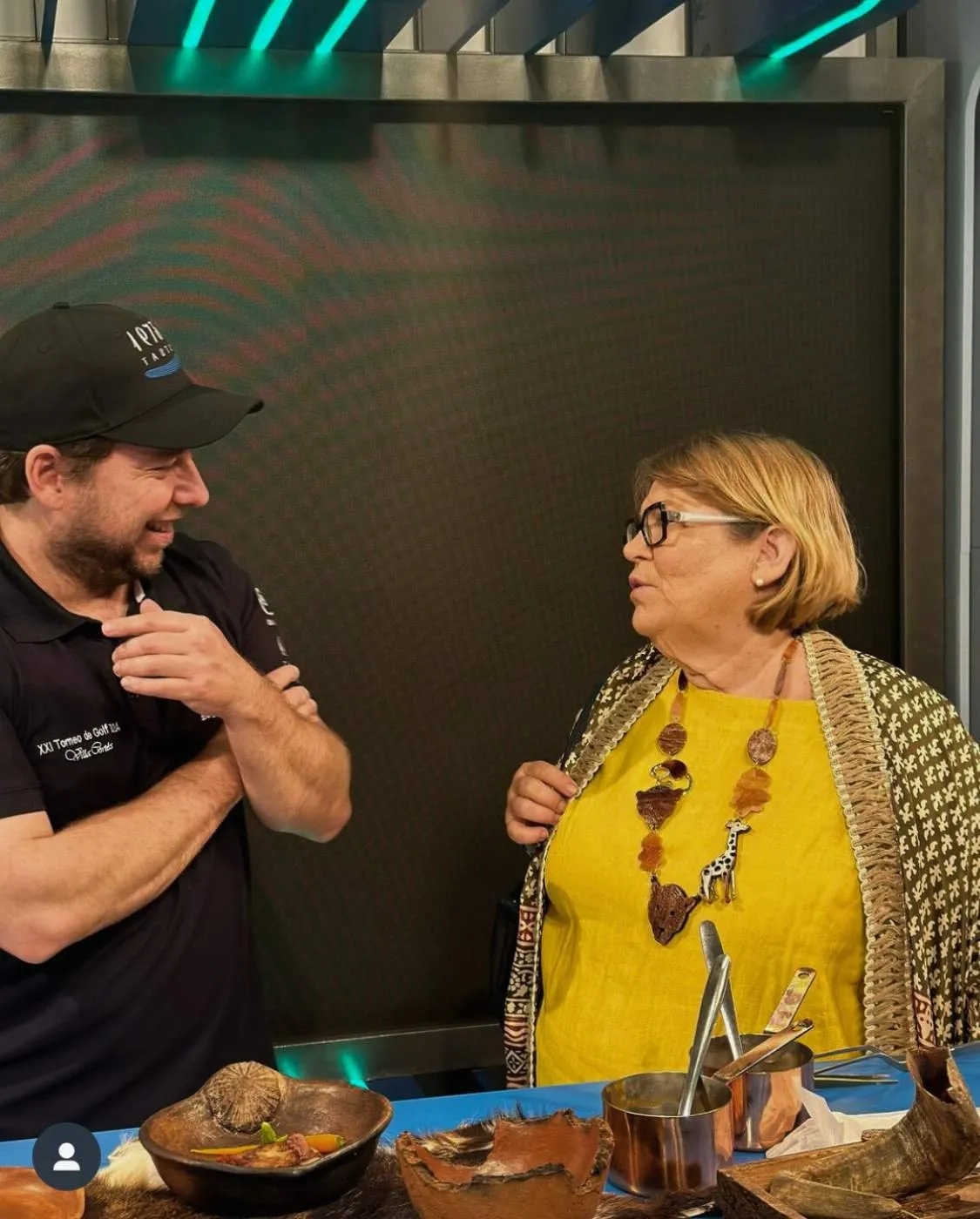 Diego Schattenhofer talks with Marichu Fresno beside the table with clay bowls