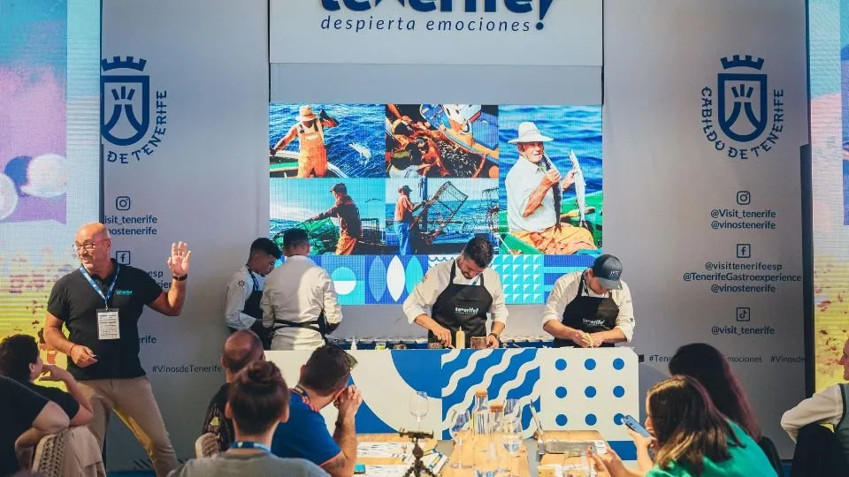 Tenerife chefs working on stage with images of fishermen on screen
