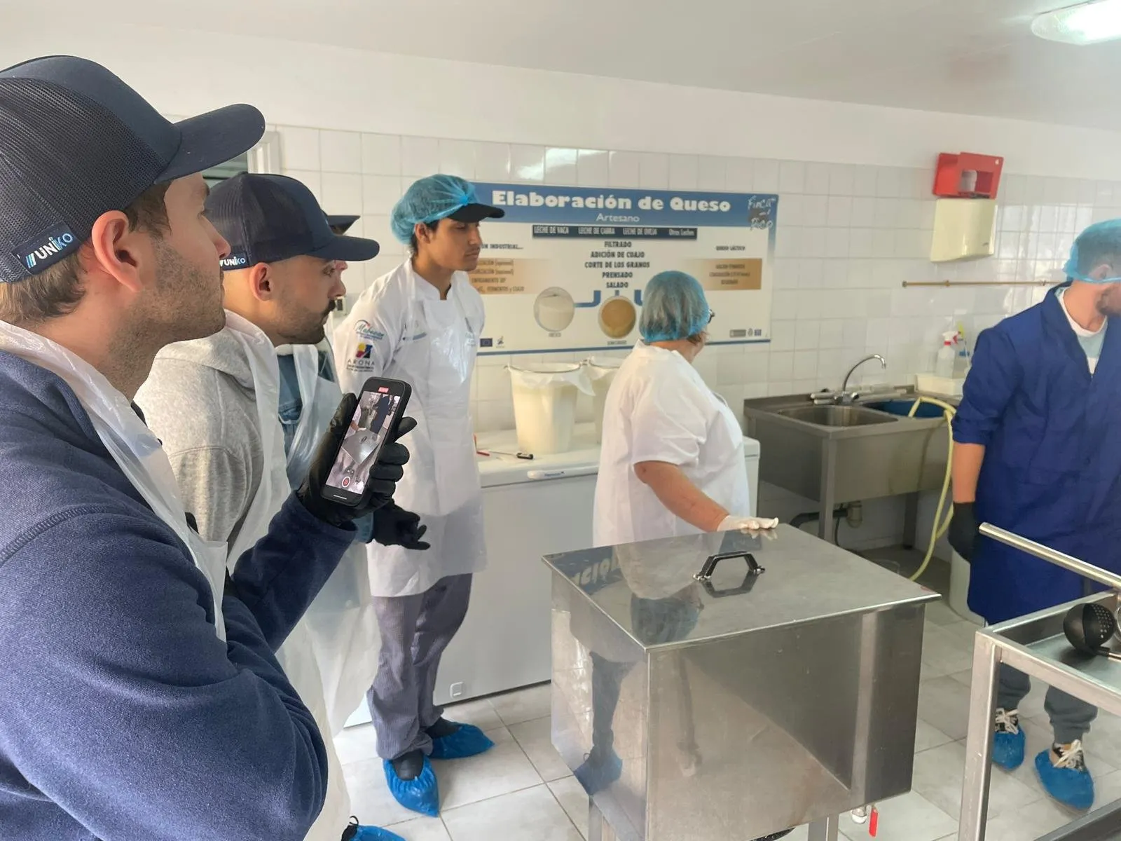 Attendees following an artisan cheesemaking demonstration in the workshop
