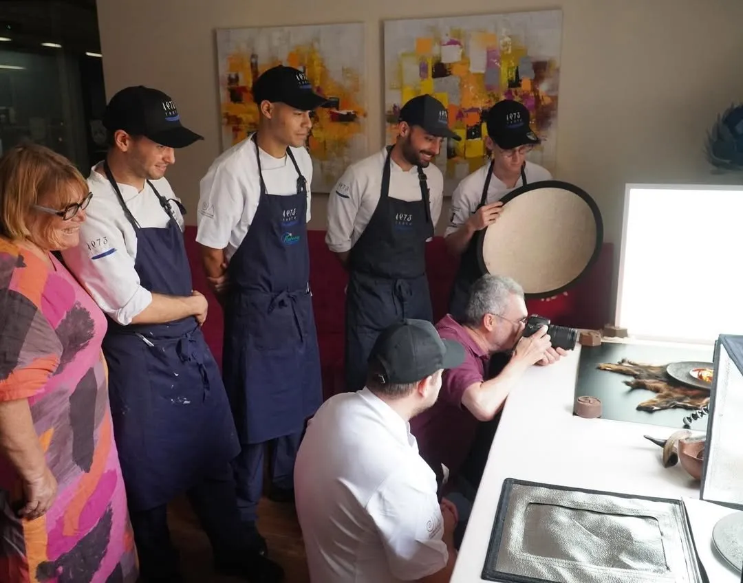 The Taste 1973 team watches the photo shoot of a piece of goat