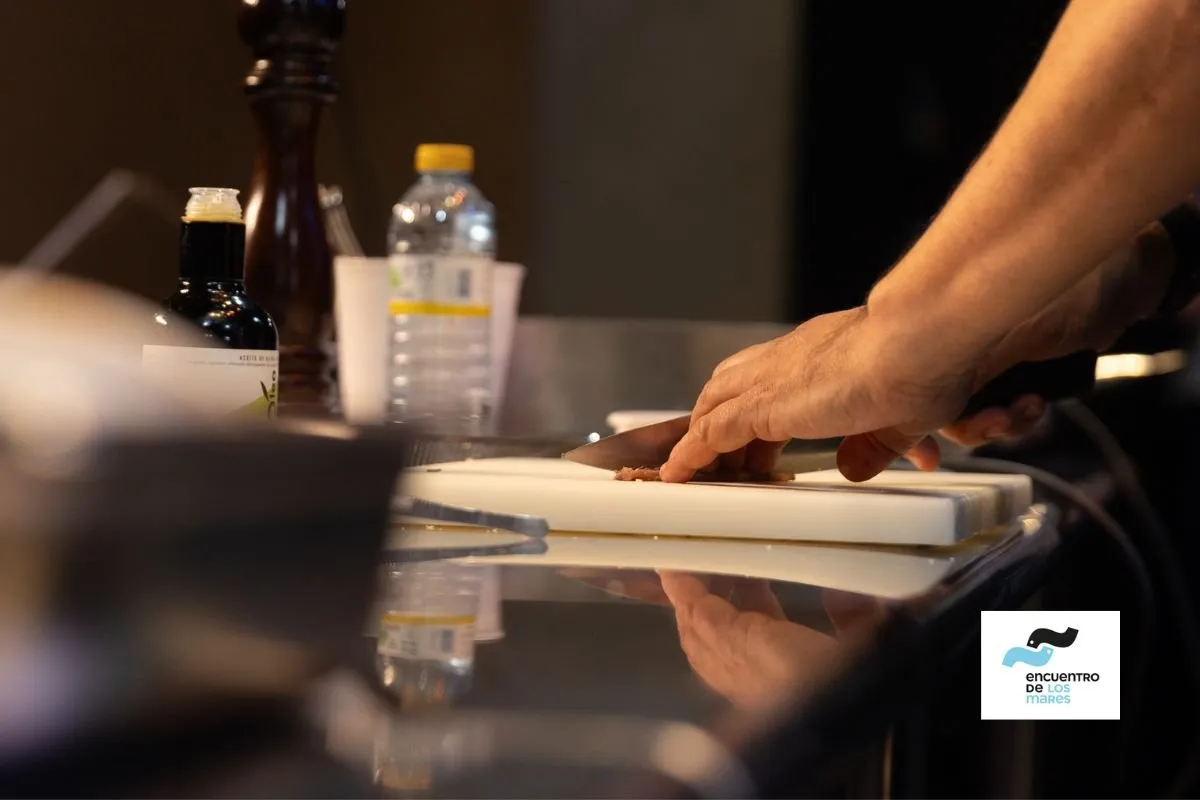 Hands working produce on a board in the congress kitchen