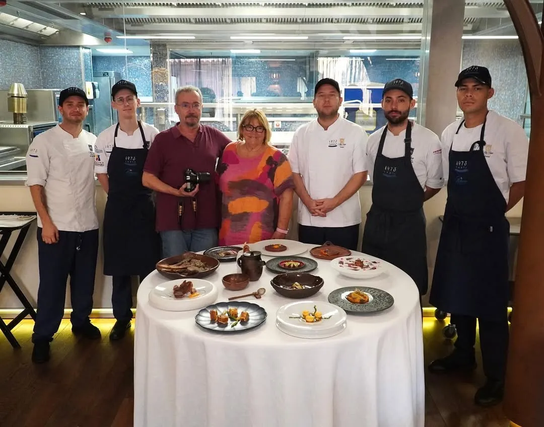 The team pose beside the table with the recipe book’s finished dishes