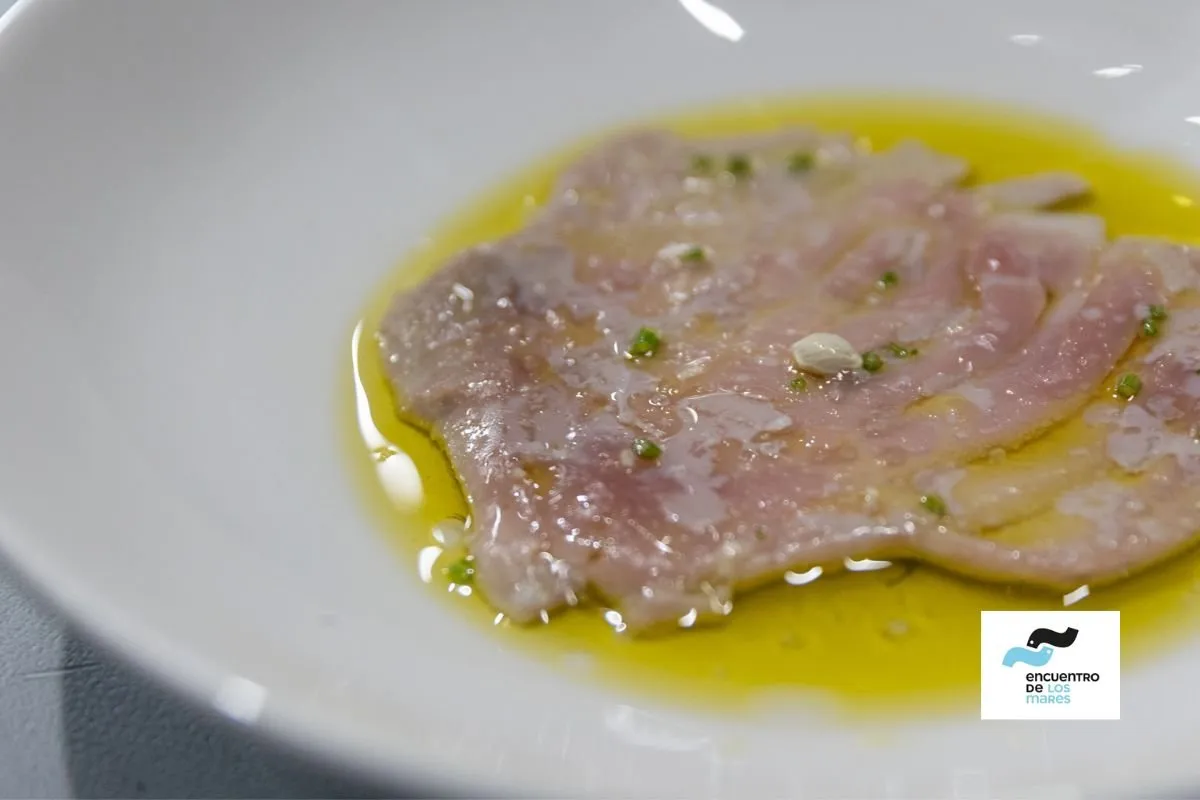 Slices of raw fish dressed with olive oil and herbs