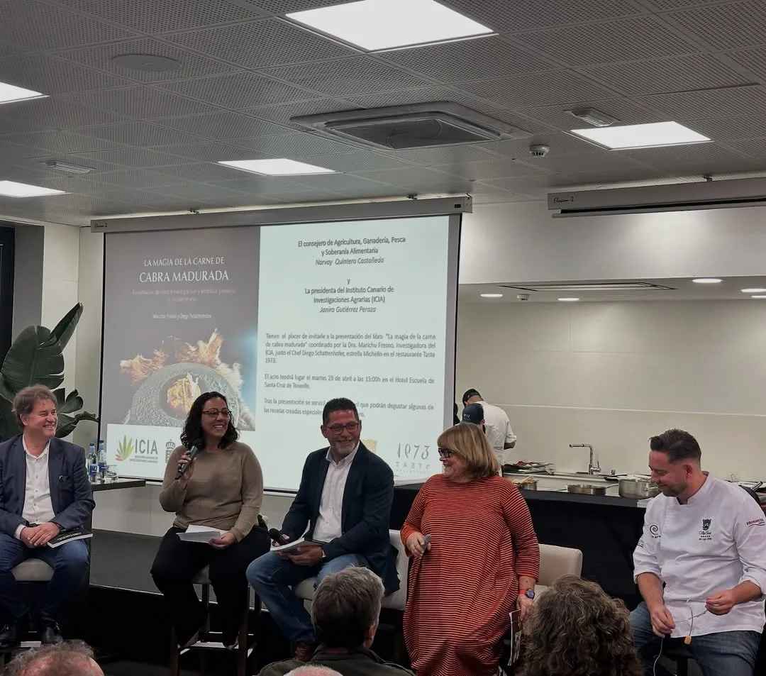 Book launch table with the speakers and the cover projected behind them