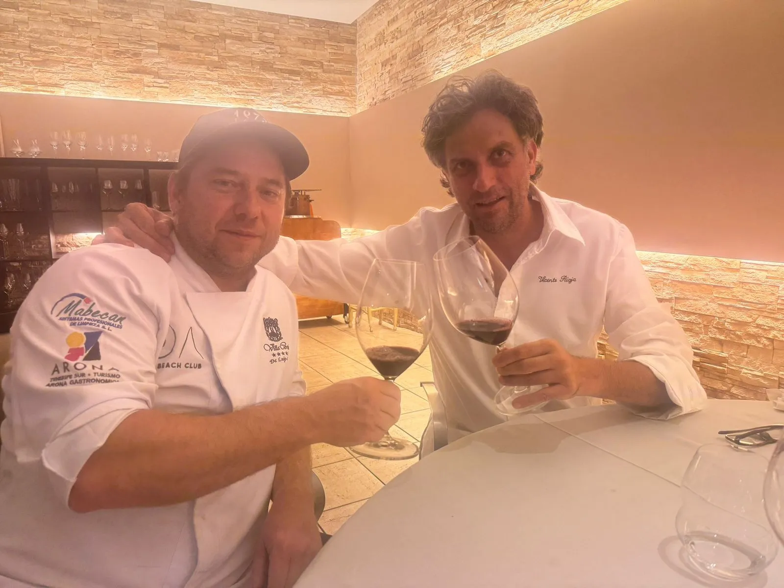 A toast with red wine at the table at the end of the day of rice dishes