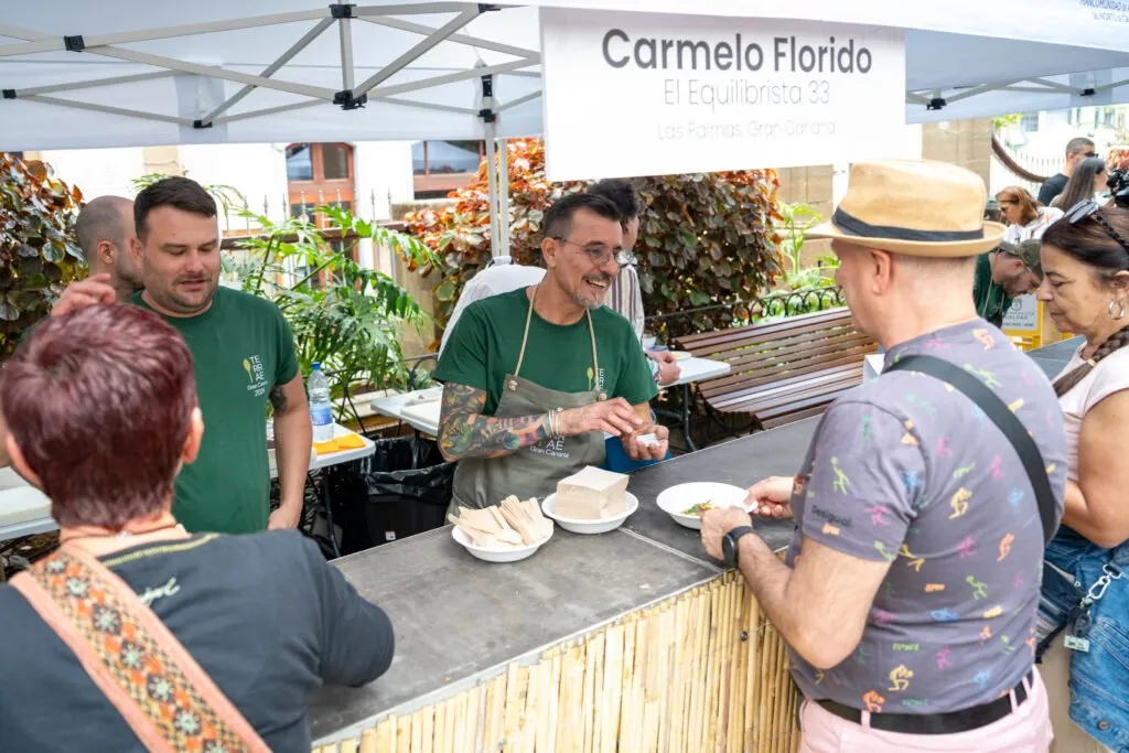Chefs serving at Carmelo Florido’s stall, with the crowd waiting at the counter