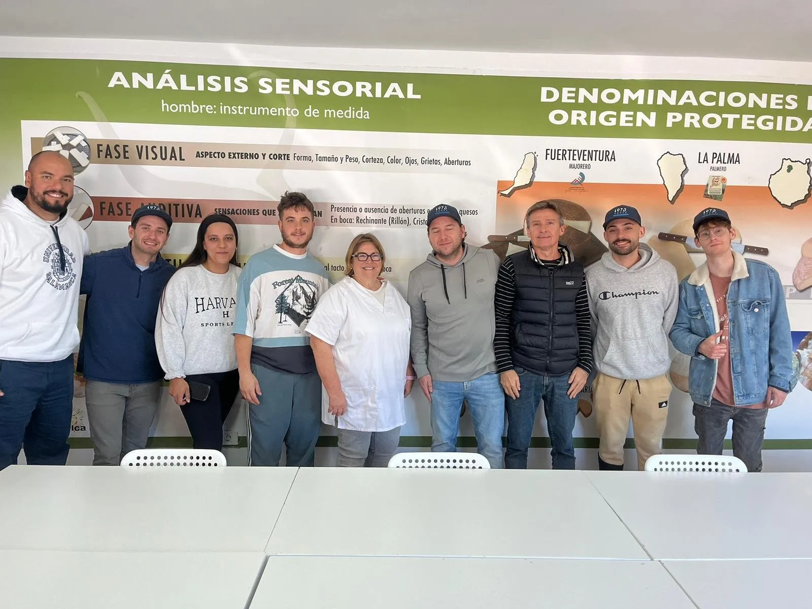 The full team in front of the sensory analysis and designation of origin panel