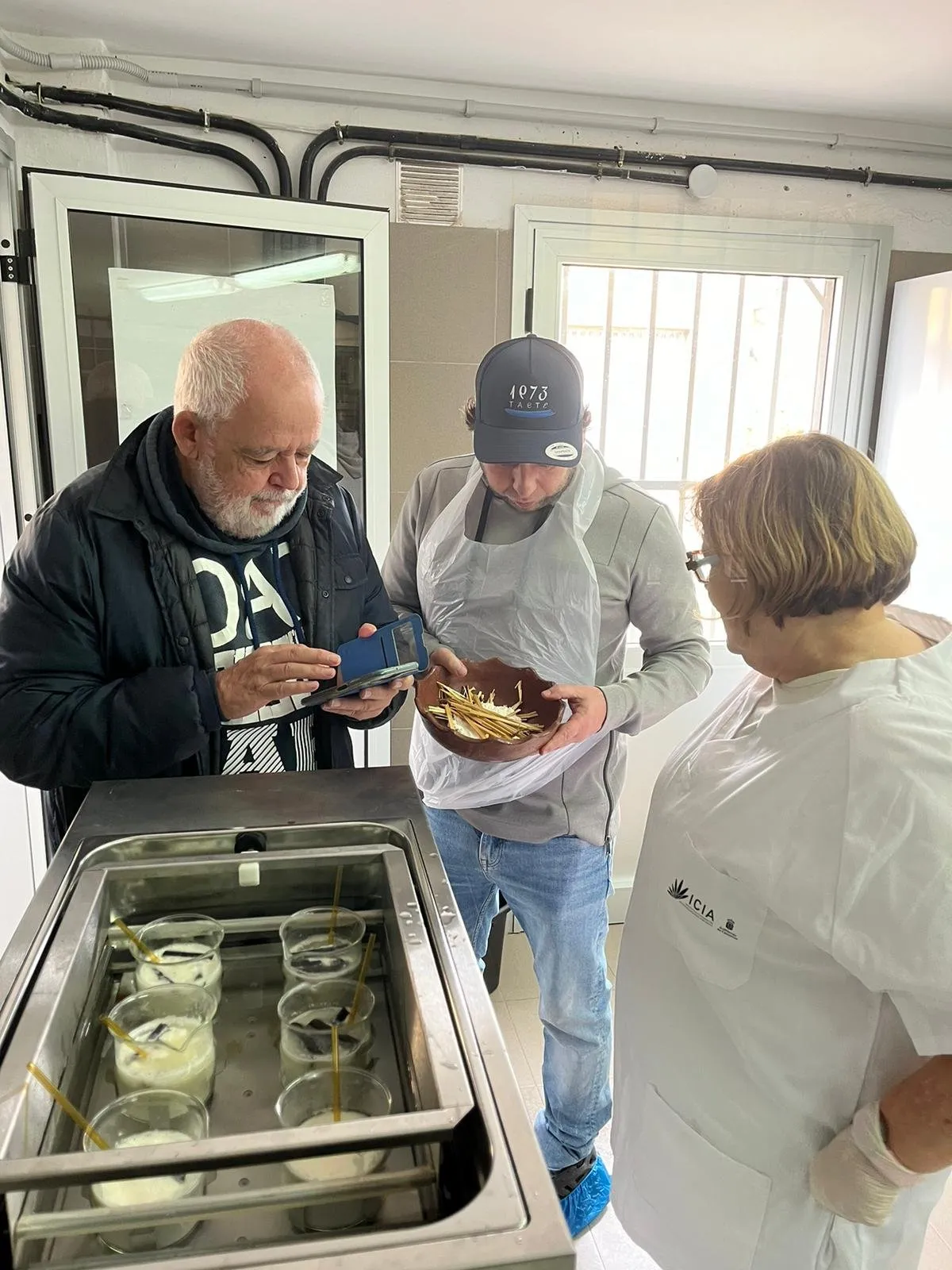 Three team members look over the tray with the cheese samples