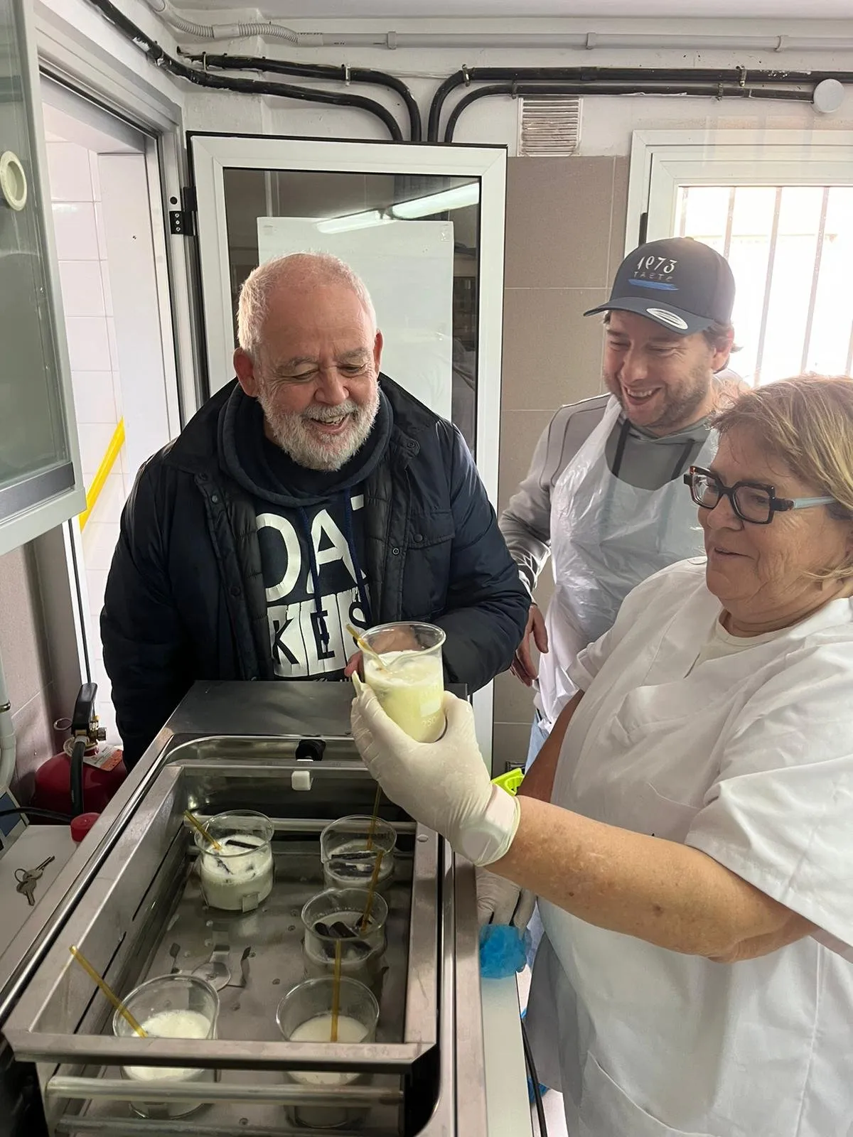 The team examines one of the cheese samples next to the steel tray