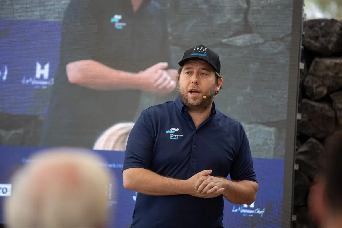 Chef Diego Schattenhofer wearing a Taste 1973 cap during his outdoor presentation