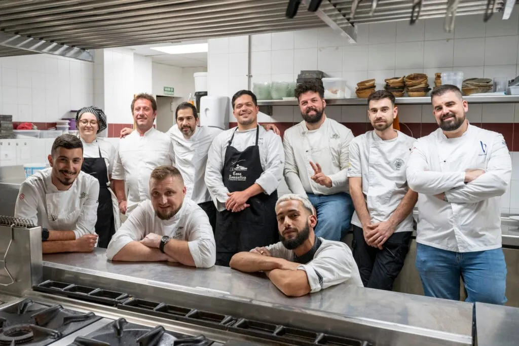The kitchen team posing by the stoves before service