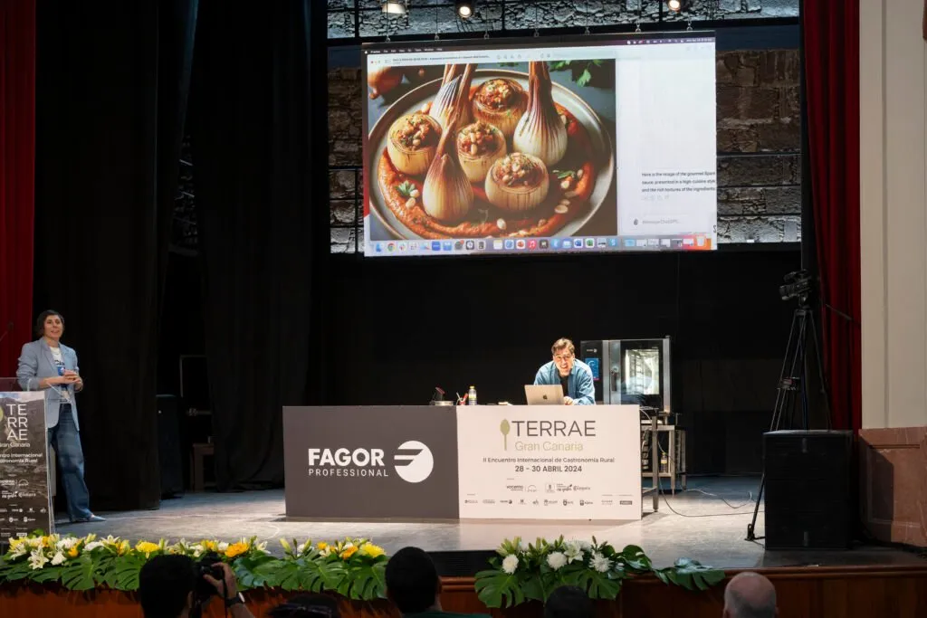 Presentation on the theatre stage with a kitchen image projected behind