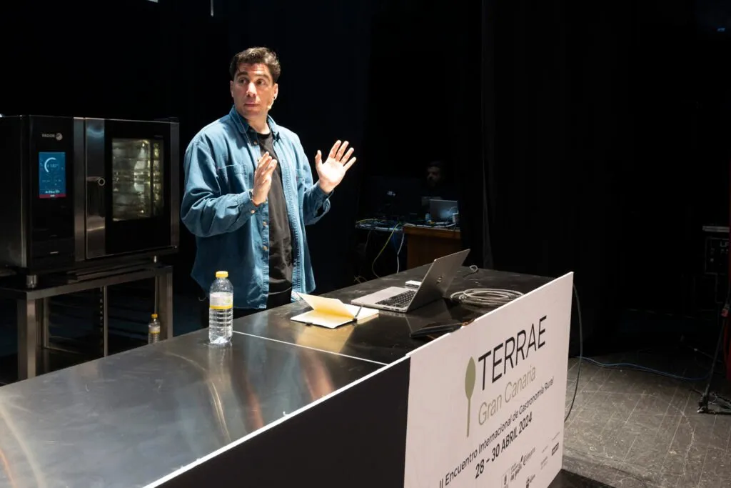 Speaker during his talk next to the oven set up on stage