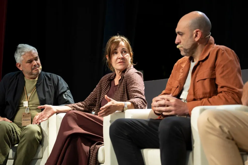 Three round table members listening to a contribution