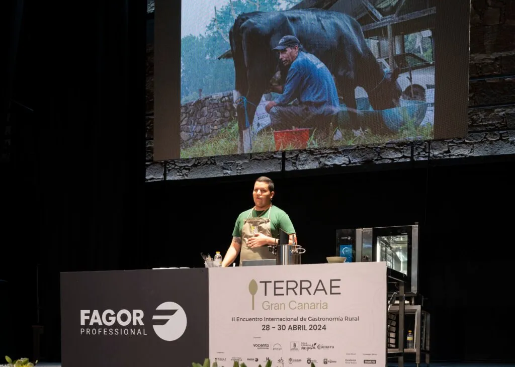 Presentation with an image of a livestock farmer milking projected on the screen