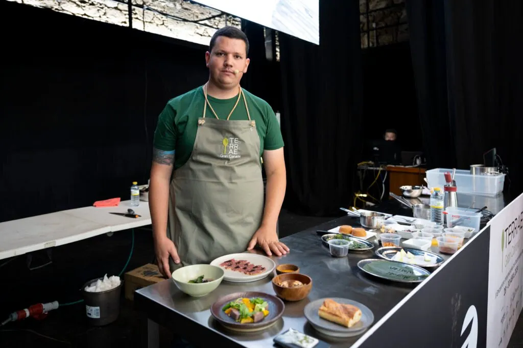 Chef behind the work table on stage during his demonstration