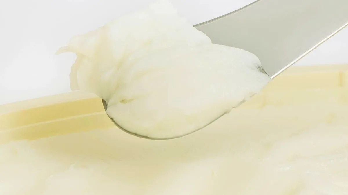 Canarian goat’s butter spread on the blade of a knife