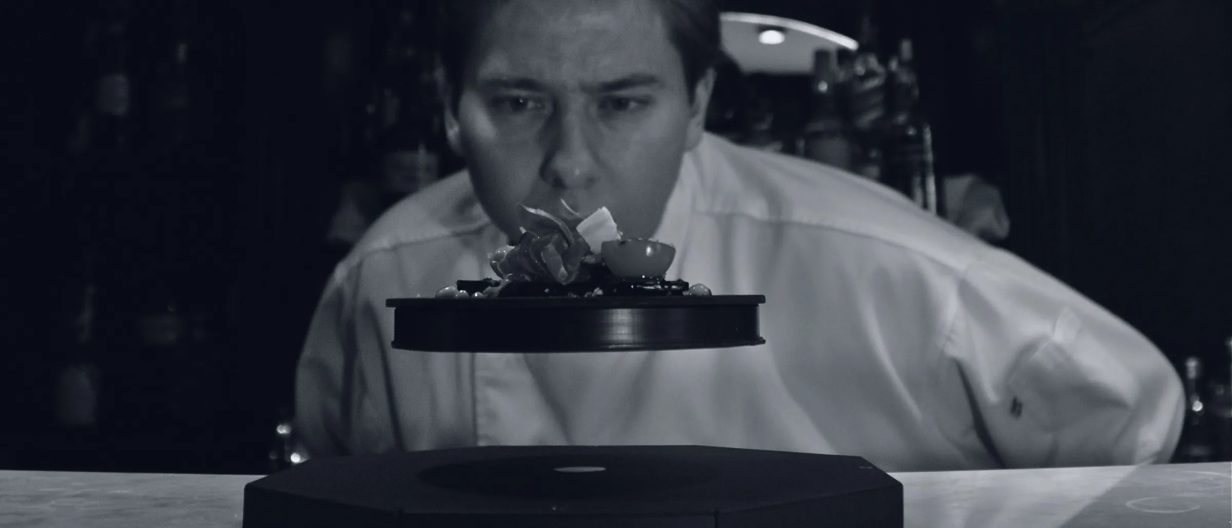 Diego Schattenhofer looks closely at a tapas dish levitating on its magnetic base