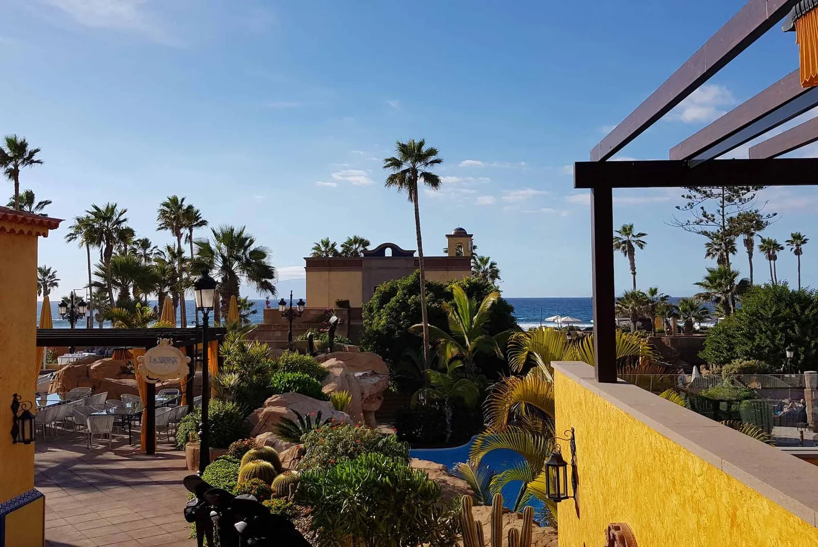 Views from La Sirena's upper terrace over the hotel gardens, the palm trees and the ocean
